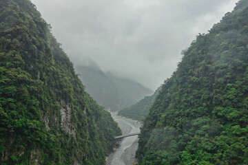 Fototapeta na wymiar A bridge crossing a small river between two mountains in Taroko national park, Taiwan