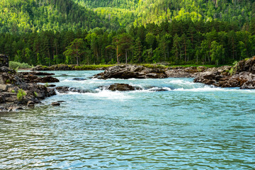 Stormy mountain river flowing along a mountain valley