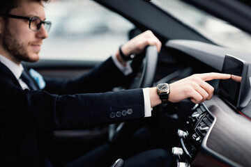 Man In Glasses Sitting In His Auto Checking Dashboard