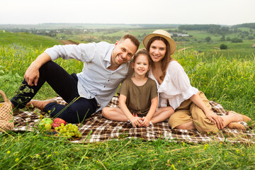 Naklejka na ściany i meble Happy family together on a picnic outdoor