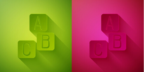 Paper cut ABC blocks icon isolated on green and pink background. Alphabet cubes with letters A,B,C. Paper art style. Vector.