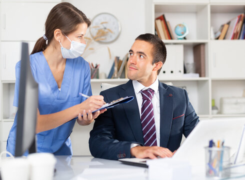 Director Of The Medical Clinic Instructs The Nurse In The Office