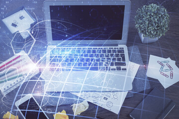 Multi exposure of table with computer and world map hologram. International data network concept.