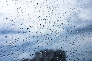 A small raindrop rests on the glass after rain.