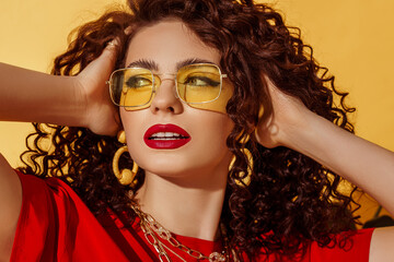 Close up summer fashion portrait of beautiful curly woman with fuchsia color lips makeup, wearing...