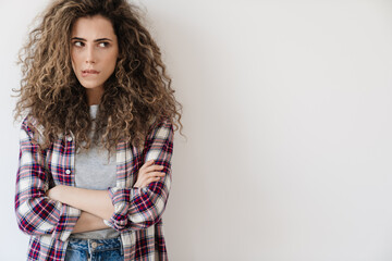 Fototapeta premium Photo of puzzled beautiful woman looking aside while posing on camera