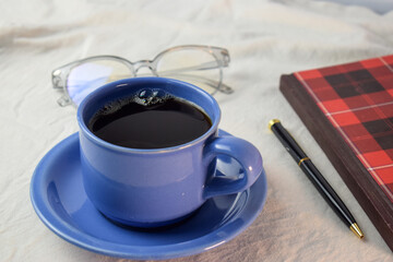 Cup Of Coffee with pen,book and glasses on white background. relax with coffee concept