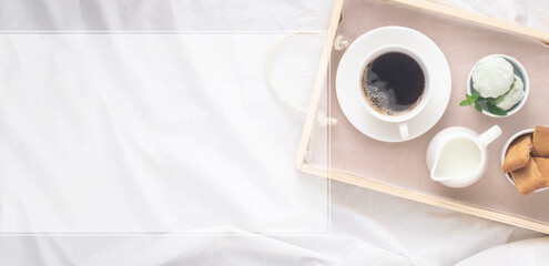 Tray with coffee and desserts on white bedding. Frame for text, banner.