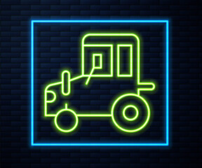 Glowing neon line Tractor icon isolated on brick wall background. Vector.
