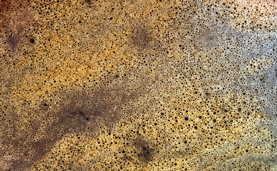 abstract background and texture from a close-up of a cafe crema, macro, warm colors