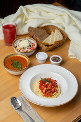 Perfect dinner in a cafe: cabbage tomato soup, pasta and coleslaw, close up photo