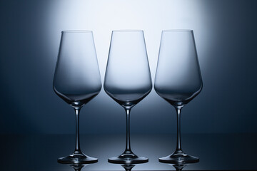 Empty wine glasses on a blue clean gradient background.