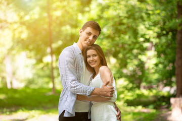 Fototapeta premium Romantic times together. Millennial couple in love embracing at sunny summer park