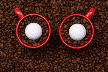 Two red cups full of coffee beans and one golf ball.  Funny owl.