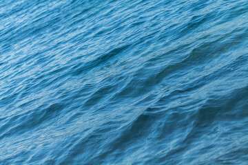 Fototapeta na wymiar Small waves on the blue sea water. Nature background, travel vacation
