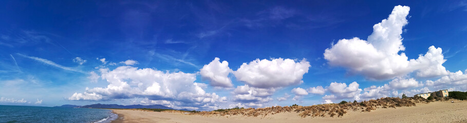Italy, Tuscany, Maremma, Marina di Grosseto panoramic photo from the beach, in the background the port and castle of Castiglione della Pescaia.