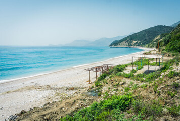 Fototapeta na wymiar A desert and crystal clear beach in the middle of Albanian Riviera, Buneci Beach, Albania. 