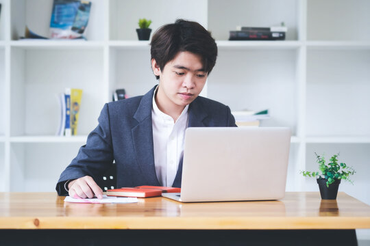 Financial analyst with business research data  information on laptop computer screen in work office..