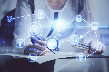 Social network theme hologram over hands taking notes background. Concept of global international people connect. Double exposure
