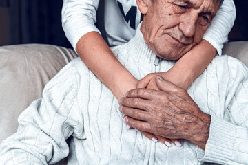 Daughter supports and takes care of her elderly father. caring for the elderly concept