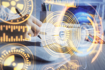 Tech theme hologram over woman's hands taking notes background. Concept of hightech. Double exposure