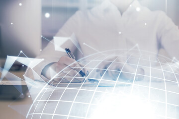 Double exposure of hands making notes with world map hologram and data theme icons. Concept of...