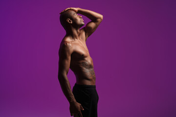 Naklejka premium Image of athletic half-naked african american man posing on camera