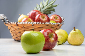 fruits in an arrangement on a white wooden surface with a white background. selective focus.