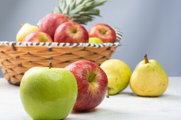 fruits in an arrangement on a white wooden surface with a white background. selective focus.