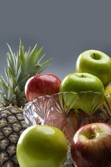 fruits in an arrangement on a white wooden surface with a white background. selective focus.