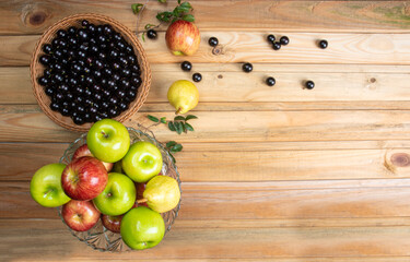 fruits in an arrangement on a light rustic wooden surface with a black background. Top view