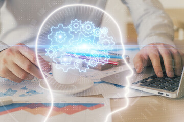 Businessman with computer background with brain theme hologram. Concept of brainstorm. Multi exposure.
