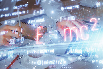 Science formula hologram with man working on computer on background. Education concept. Double...