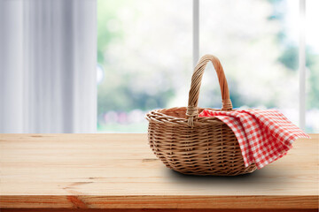Empty basket with red napkin picnic on table place. Spring background.