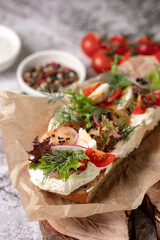 Close up tasty chinese noodle food with pork and vegetables in take-out box on yellow background with hard light. Cute happy Maneki neko lucky cat and chinese lantern on table.