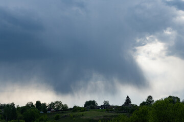 Obraz na płótnie Canvas Storm clouds above a mountain village