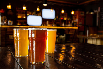 Relax with friends. Dark, light, unfiltered beer in big glasses on wooden table