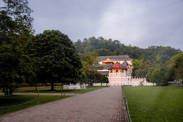 Temple of the tooth, a Buddhist temple also known as Sri Dalada Maligawa in Kandy, Sri Lanka. Evening view with sunlight, well famous destination among tourists. 