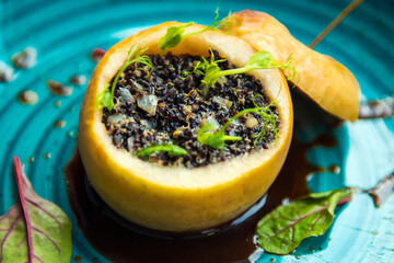 Delicious quinoa with sprouts backed in an apple, nicely decorated vegetarian food, close up