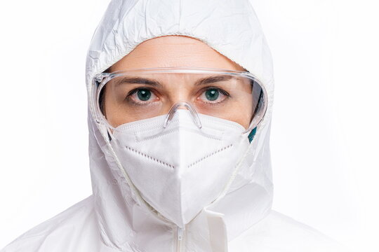 Female doctor with PPE looking at camera with white background