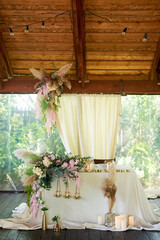 Wedding design with wildflowers and pampas. Boho style. The bride and groom's table. Floristics.