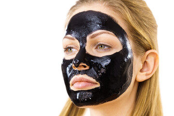 Woman with black peel off mask on face