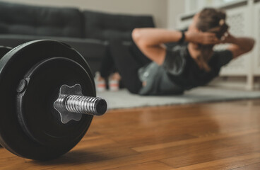 Woman doing crunch exercise. Home fitness training concept.