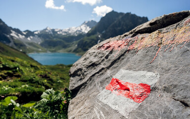 Trail marking on mountains. Painted mark in red and white for tourist, hikers and trekkers. It...