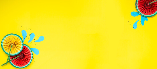 Paper fruit origami watermelon fan decoration. Creative banner with copy space on bright yellow background. Tropics summer