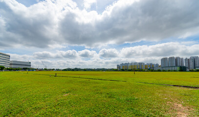 An array of multi-storey buildings in the middle of the field sky background in singapore city. decoration image contain certain grain noise and soft focus.