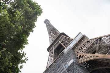 close-up Eiffel Tower, landmark of Paris, during renovation process. view with iron construction detail.