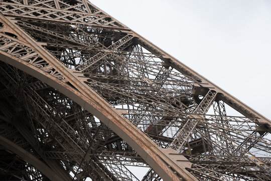 close-up Eiffel Tower, landmark of Paris, during renovation process. view with iron construction detail. - Powered by Adobe