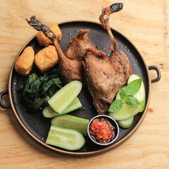Bebek Goreng, Traditional Fried Duck Menu in Indonesian. Popular Menu came from Madura, East Java. Usually Served with Raw Vegetable and Spicy Sambal. Popular as Penyetan