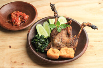Bebek Goreng, Traditional Fried Duck Menu in Indonesian. Popular Menu came from Madura, East Java. Usually Served with Raw Vegetable and Spicy Sambal. Popular as Penyetan